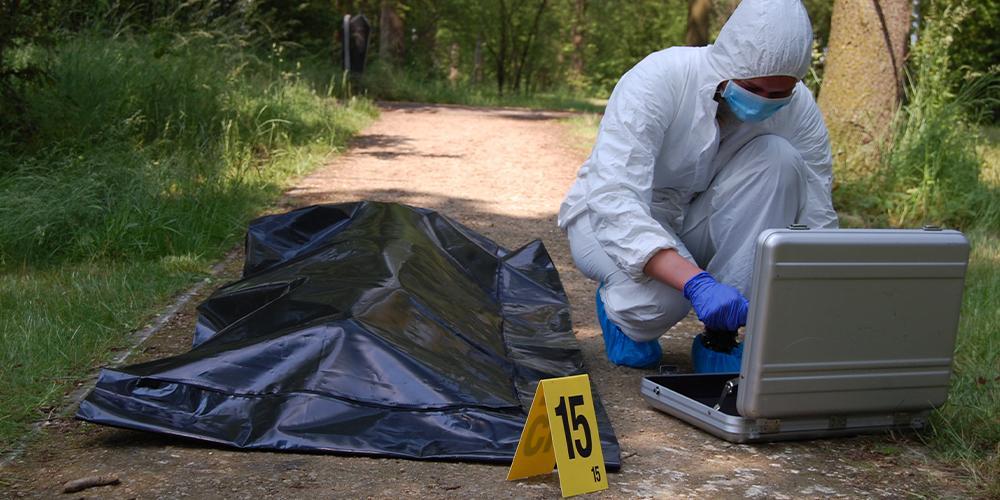 A forensic investigator examines a crime scene